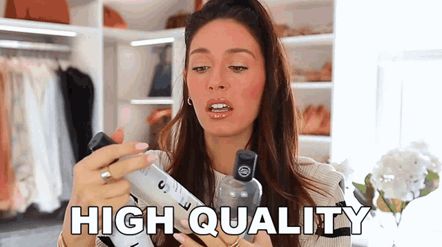 a woman holding a spray bottle with the words high quality written on it