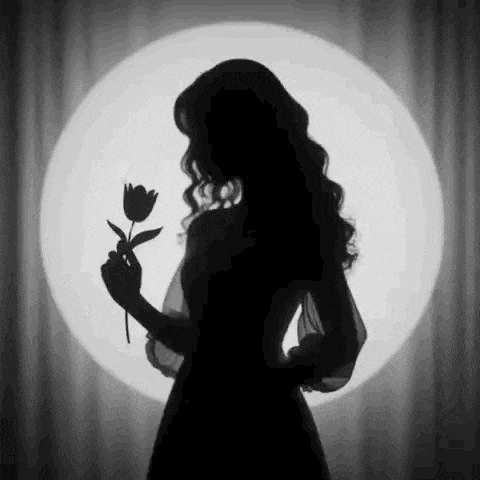 a black and white silhouette of a woman holding a flower in front of a light .
