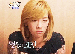 a woman with blonde hair is making a funny face and looking at the camera .