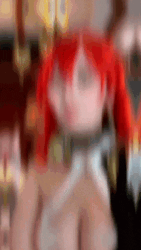 a blurred image of a woman with red hair and sunglasses .