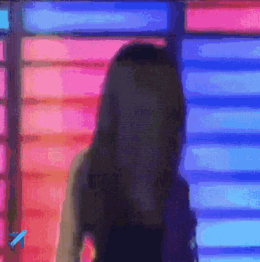 a woman is standing in front of a colorful background with an airplane in the corner