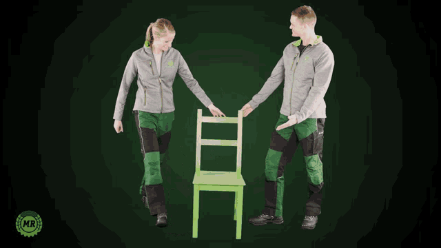a man and a woman standing next to each other with a green chair in front of them