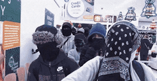 a group of people are standing in a line in a store .