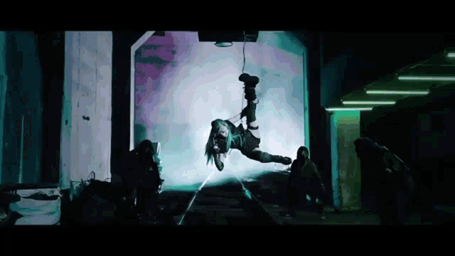 a woman is hanging from a rope in the air