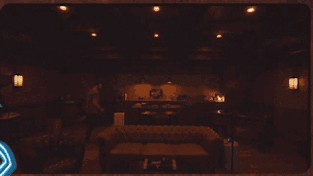 a man is standing in a dark room with a couch and chairs