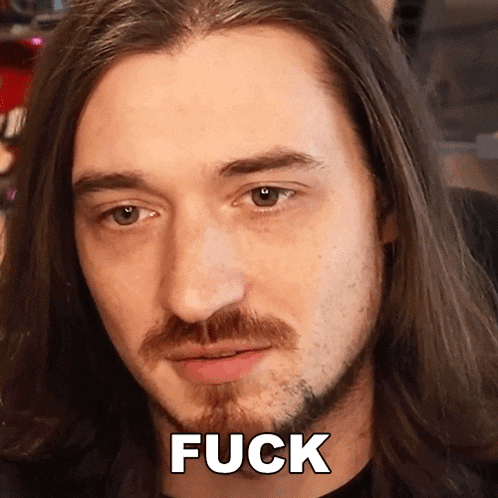 a man with long hair and a beard says the word fuck