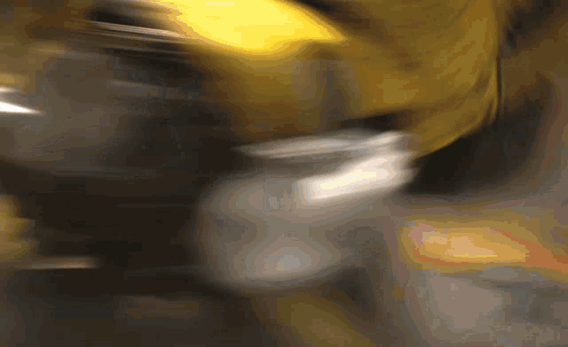 a blurry picture of a person 's face with a yellow light behind them