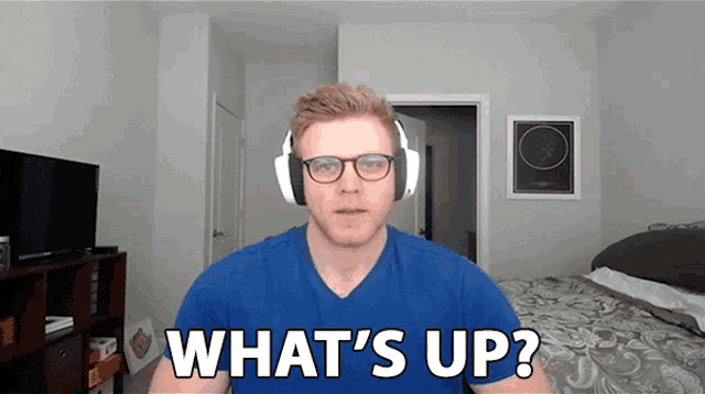 a man wearing headphones says " what 's up "