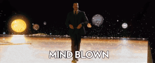 a man in a suit and tie is dancing with the words mind blown written below him