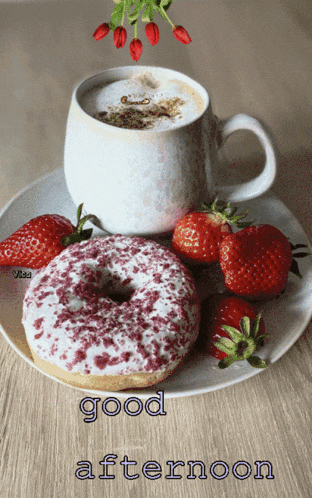 a donut and strawberries on a plate with a cup of coffee