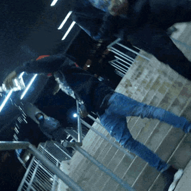 a man is standing on a set of stairs holding a skateboard