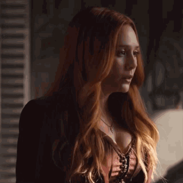 a close up of a woman with red hair