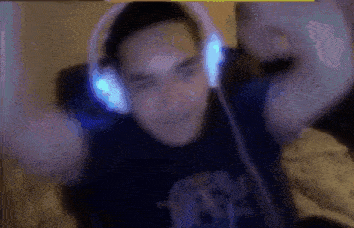 a man wearing headphones is sitting on a couch .