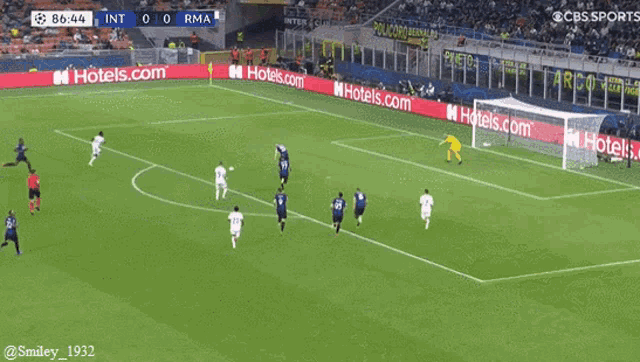 a soccer game is being played in a stadium with hotels.com advertisements