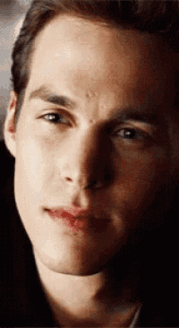 a close up of a young man 's face with a smile on his face