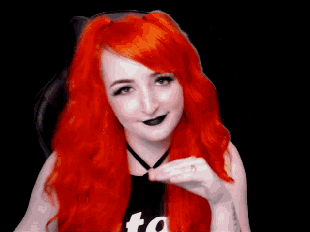 a woman with red hair is wearing a black shirt that says " to "