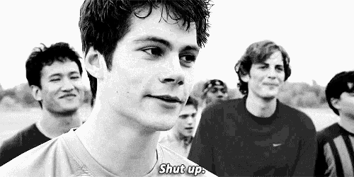 a group of young men are standing next to each other in a black and white photo and one of them is saying shut up .