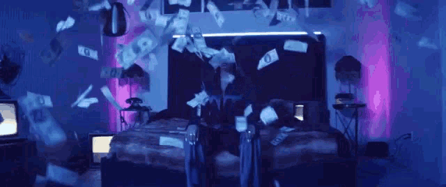 a bunch of money is falling from the ceiling on a bed .
