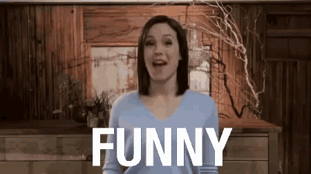 a woman in a blue sweater is making a funny face