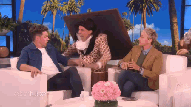 three men are sitting on a couch with ellentube written on the bottom