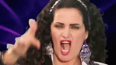 a woman with a headband on her head is making a funny face