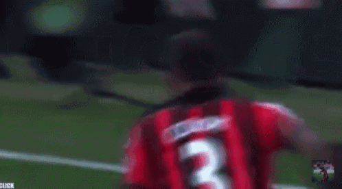 a blurry picture of a soccer player with the word rise behind him