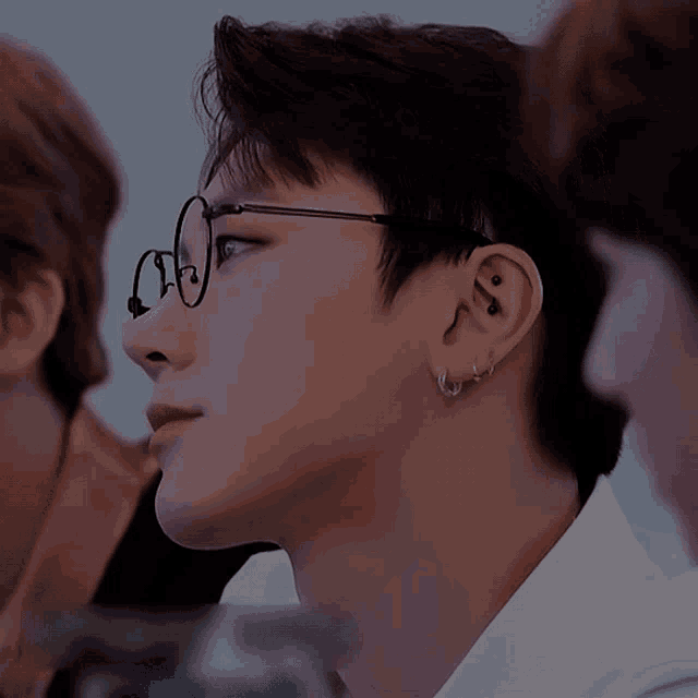 a close up of a person 's face with glasses on