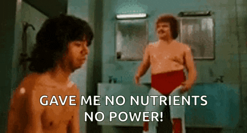 two men are standing in a bathroom with the words `` gave me no nutrients no power '' .