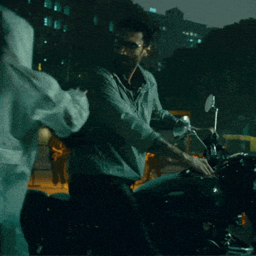 a man standing next to a motorcycle with the word bullet on the front