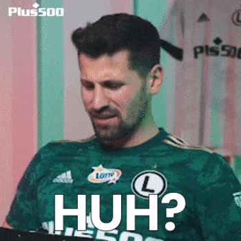 a man wearing a green shirt that says huh