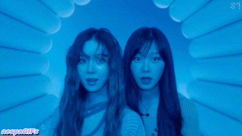 two girls are standing in a tunnel with a watermark that says megangifs
