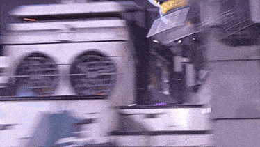 a blurred image of a machine with a yellow sticker on it that says ' warning '