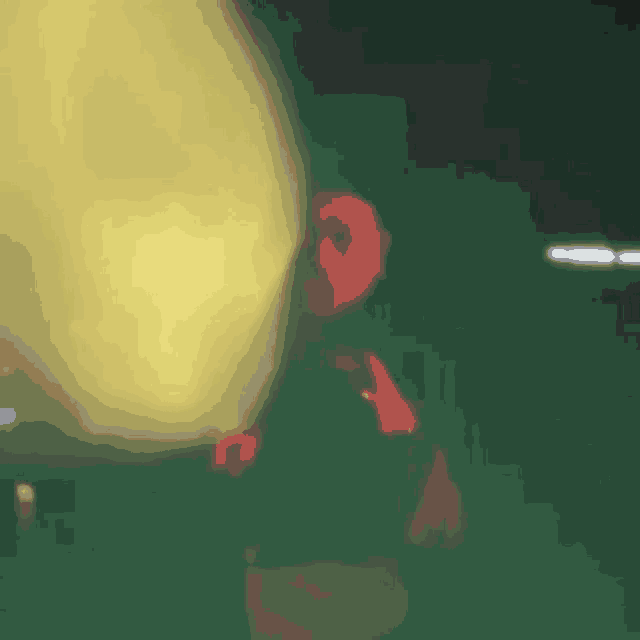 a blurry picture of a person standing in front of a yellow object .