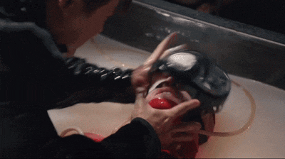 a person is putting a mask on a person 's head