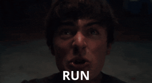 a close up of a person 's face with the word run behind him