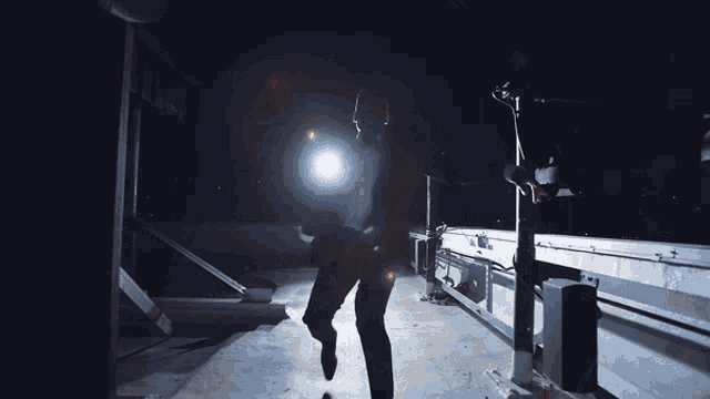 a person is standing in the dark with a light shining on them