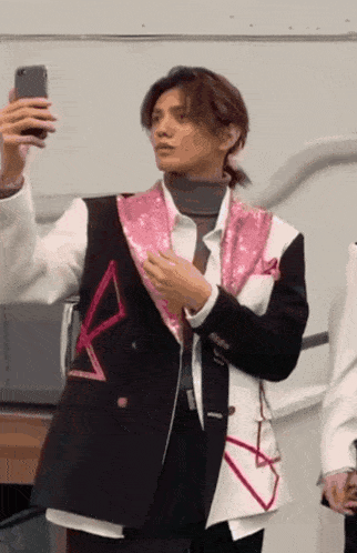 a man is taking a picture of himself with a cell phone
