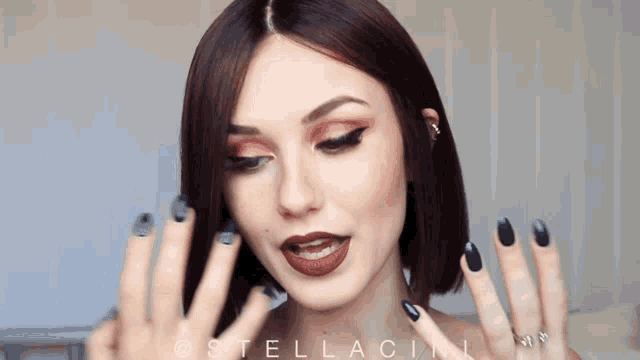 a close up of a woman 's face with the name stellacini on the bottom right