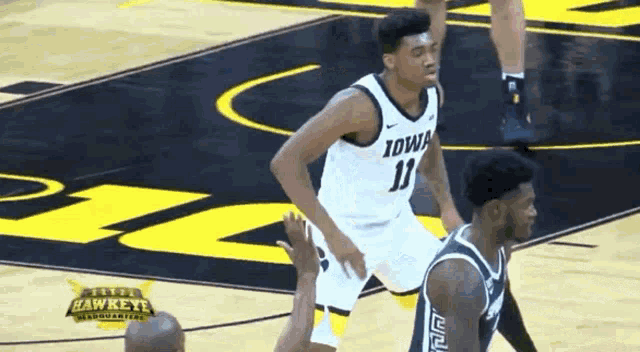 a basketball player with the number 11 on his jersey dribbles the ball