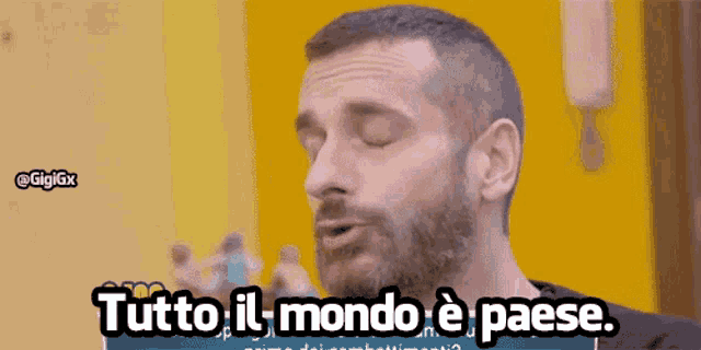 a man with a beard is saying tutto il mondo e paese