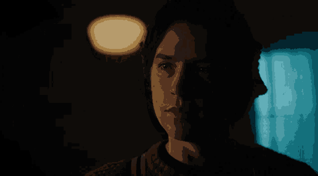 a close up of a person 's face with a light behind them