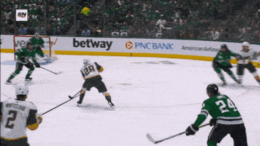 a hockey game is being played in front of a pnc bank sign