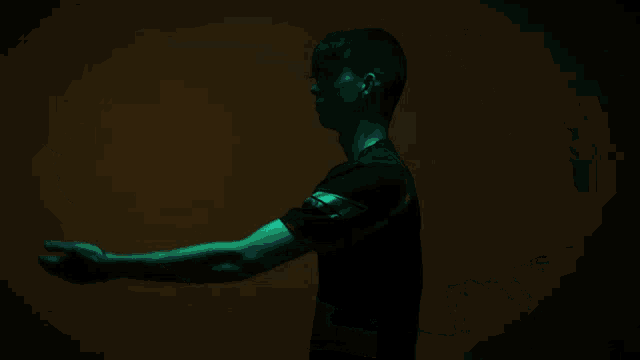 a man wearing a black shirt with the word gains on it