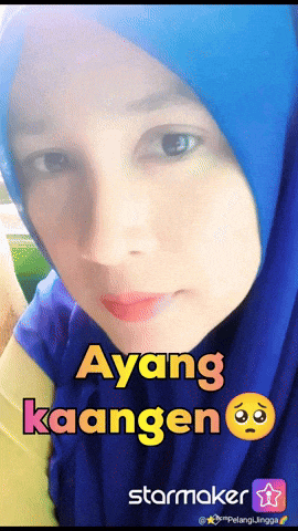 a woman wearing a blue head scarf with the words " ayang kaange " on it