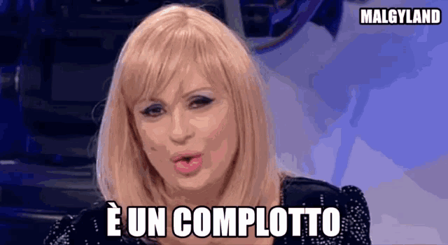 a woman with blonde hair is making a funny face and says e un completto