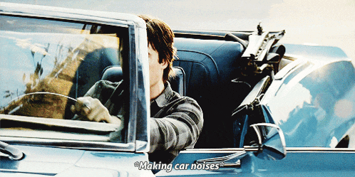 a man driving a car with the words making car noises written on the side