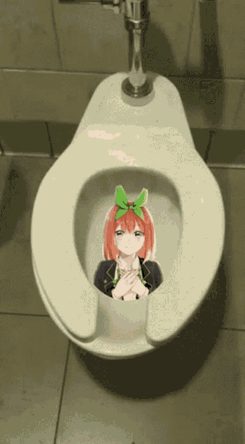 a toilet with a sticker of a girl with a green bow on her head