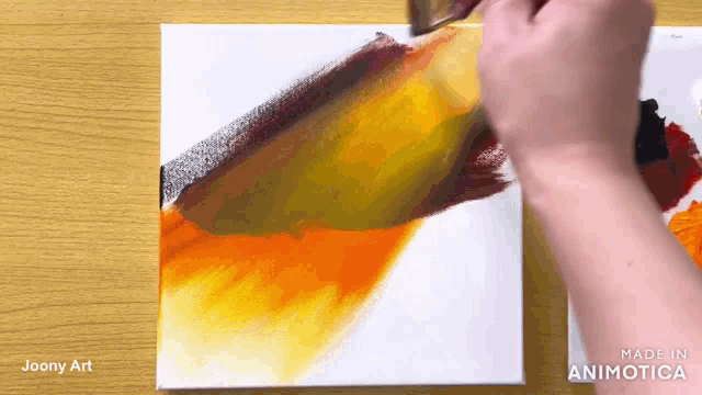 a person is painting on a canvas with the words made in animatica on the bottom right