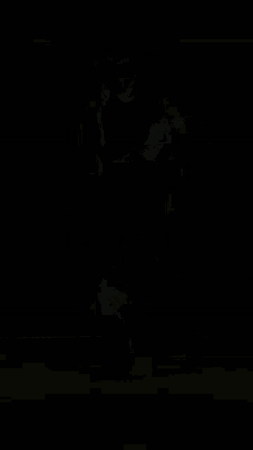a man wearing a nike hoodie is juggling a basketball on his foot