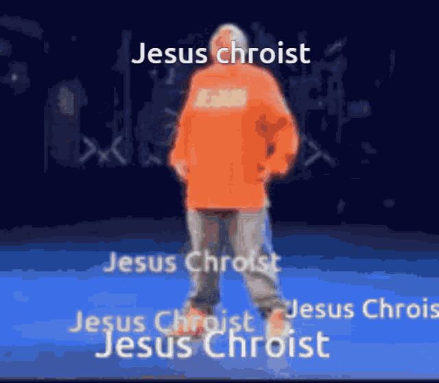 a man in an orange hoodie is standing in front of a blue background with the words jesus chroist written on it